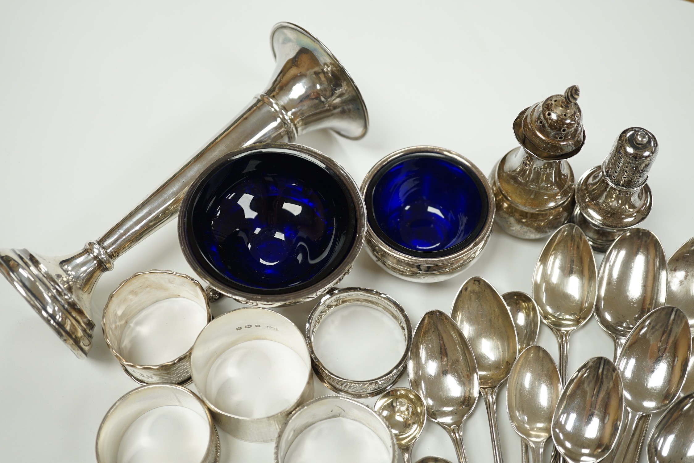 A small collection of assorted small silver including five napkin rings, a posy vase, two pepperettes, two small salts including Irish(marks very rubbed) and twenty eight small spoons.